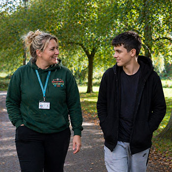 Child walking with therapist in Wrexham city centre