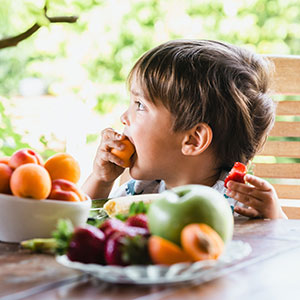 Child eating fruit in Wrexham